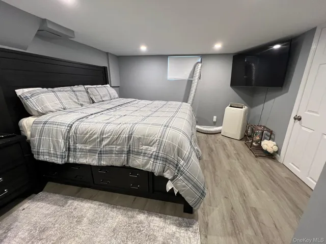 a bedroom with a bed and a view of kitchen