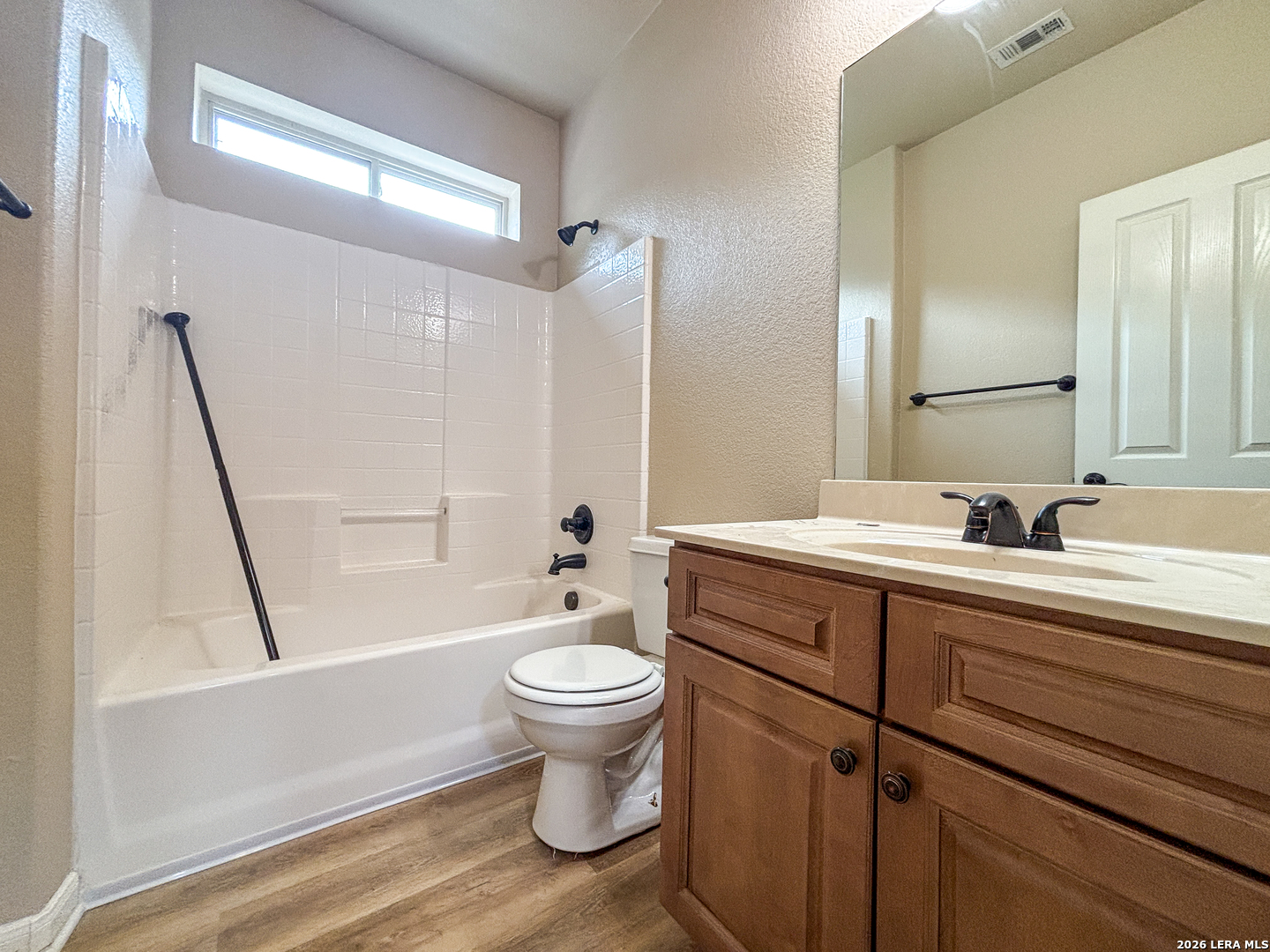 1908 Tanger Terrace New Braunfels, TX 78130 - Photo 13 of 22 a bathroom with a sink toilet a mirror and shower