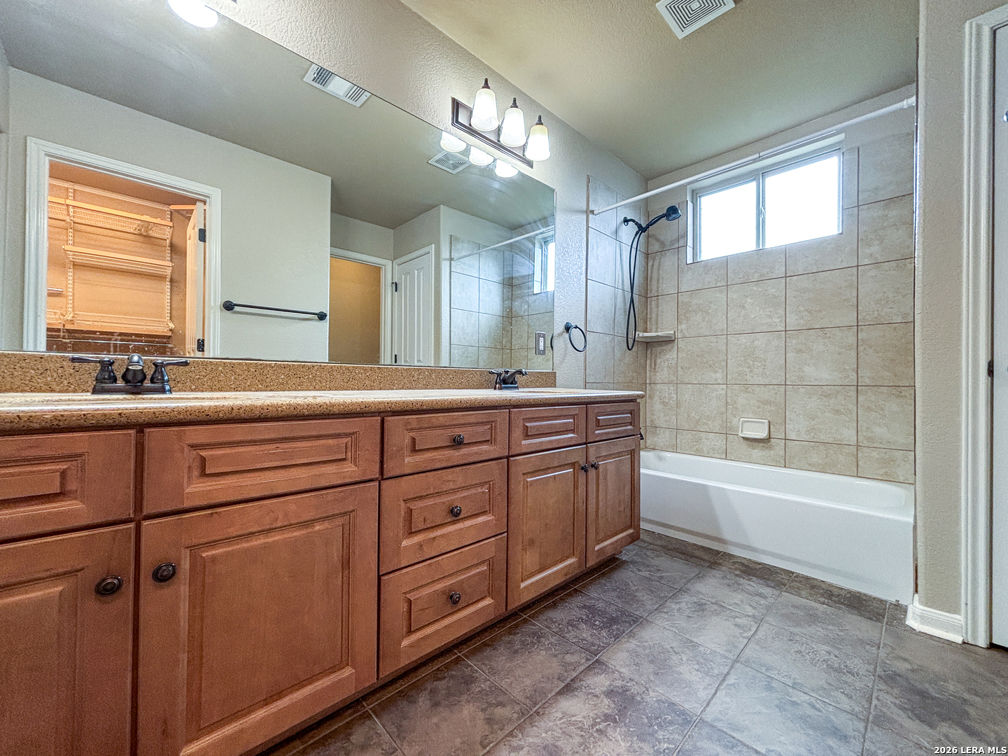 1908 Tanger Terrace New Braunfels, TX 78130 - Photo 16 of 22 a bathroom with a tub sink and mirror