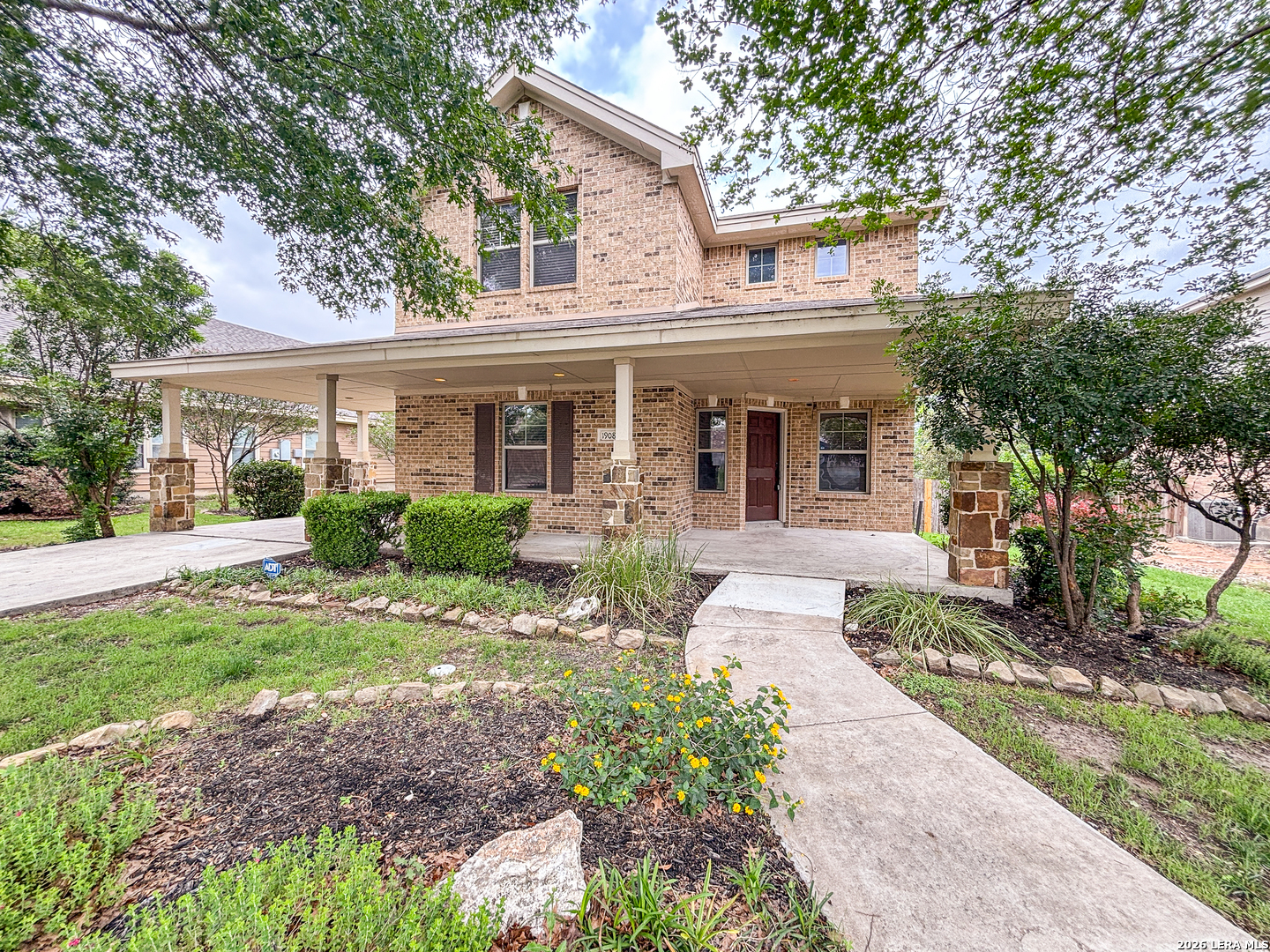 1908 Tanger Terrace New Braunfels, TX 78130 - Photo 2 of 22 a front view of a house with garden and porch