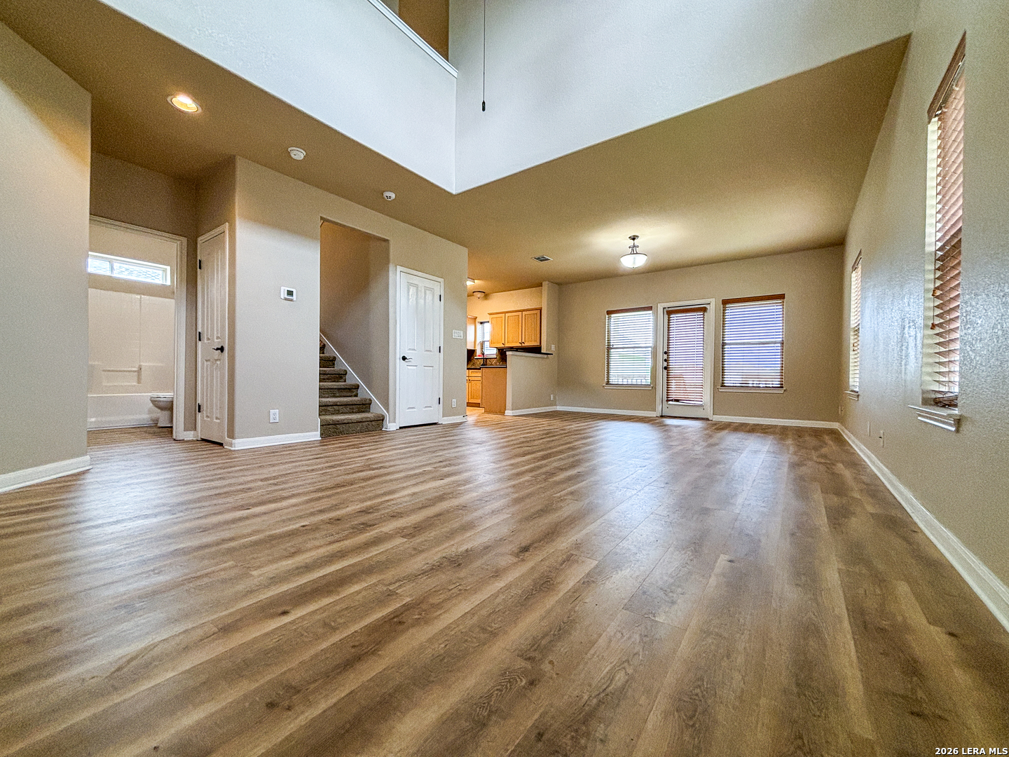 1908 Tanger Terrace New Braunfels, TX 78130 - Photo 4 of 22 a view of a room with wooden floor and a window