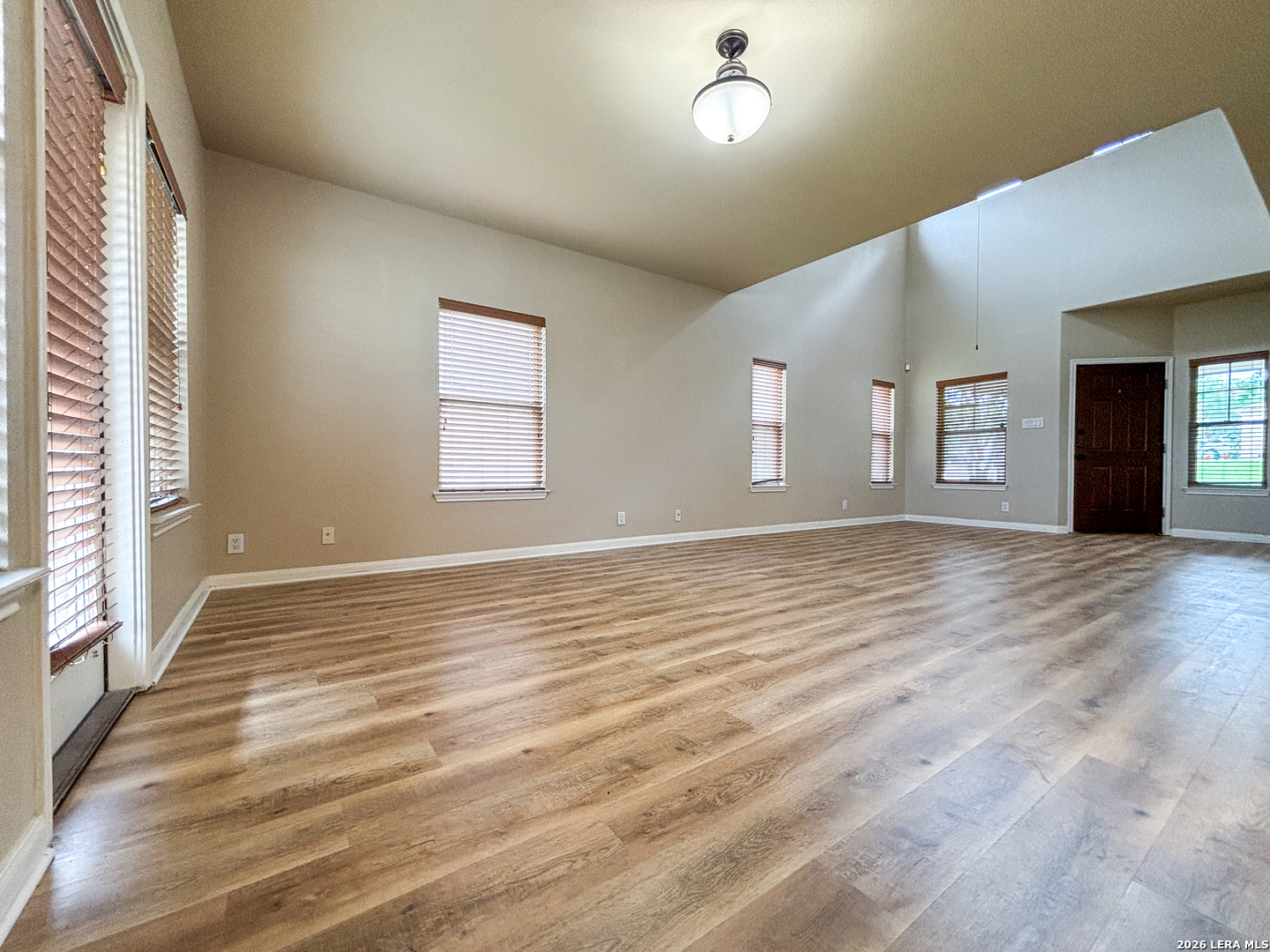 1908 Tanger Terrace New Braunfels, TX 78130 - Photo 5 of 22 a view of an empty room with window and wooden floor