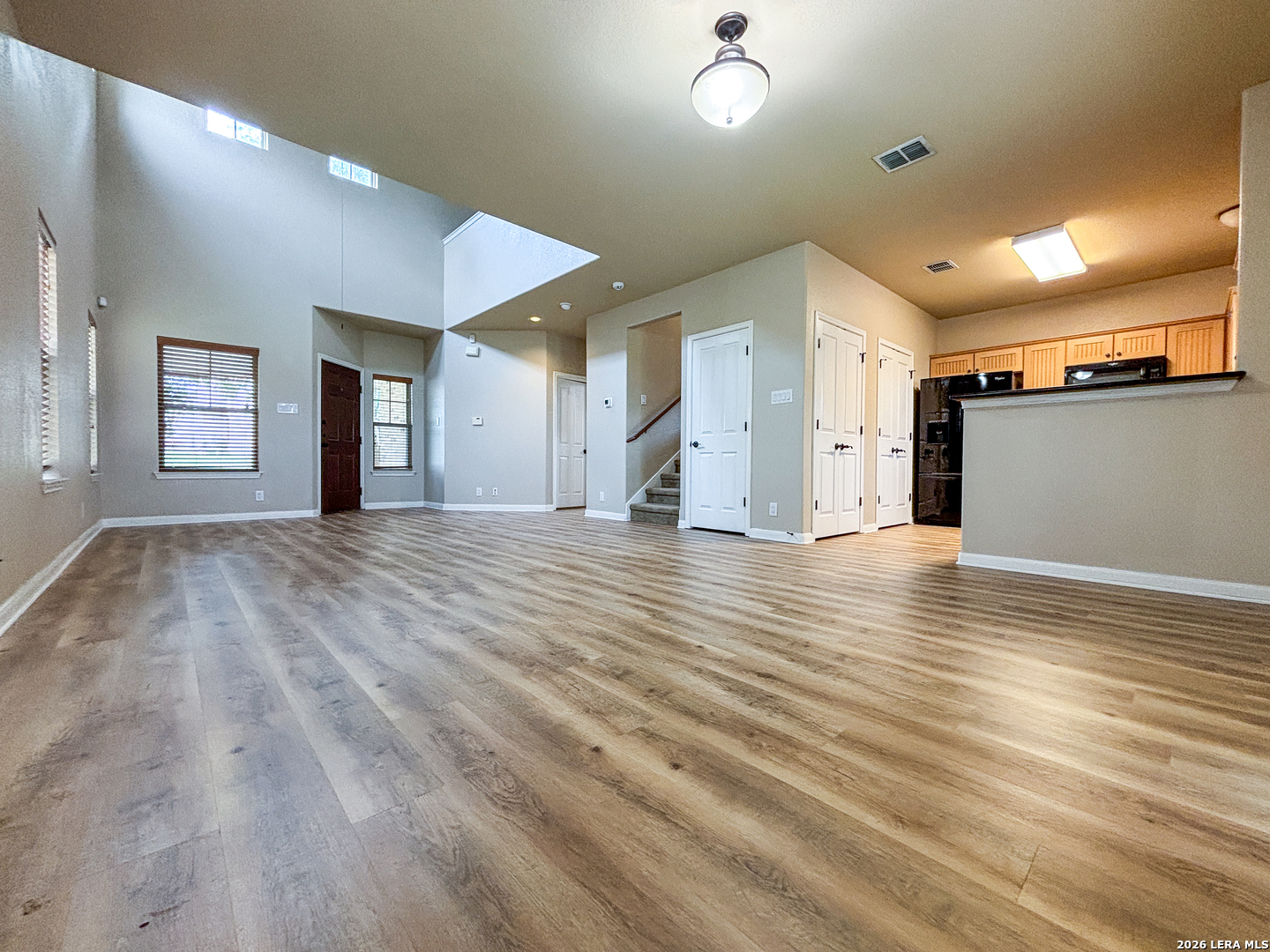 1908 Tanger Terrace New Braunfels, TX 78130 - Photo 6 of 22 an empty room with wooden floor and windows