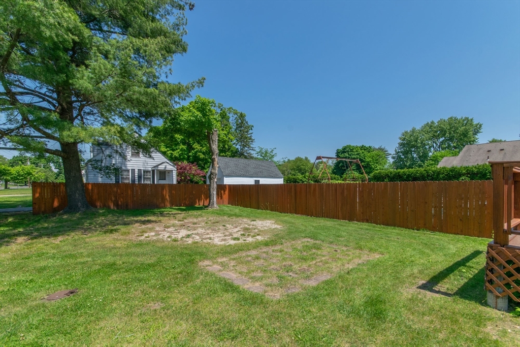 1660 Wilbraham Road Springfield, MA 01119 - Photo 31 of 31 a view of a back yard with an tree and wooden fence