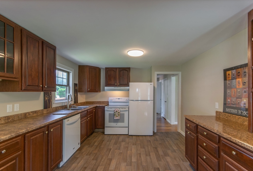 1660 Wilbraham Road Springfield, MA 01119 - Photo 8 of 31 a kitchen with a sink a refrigerator a counter top space and cabinets