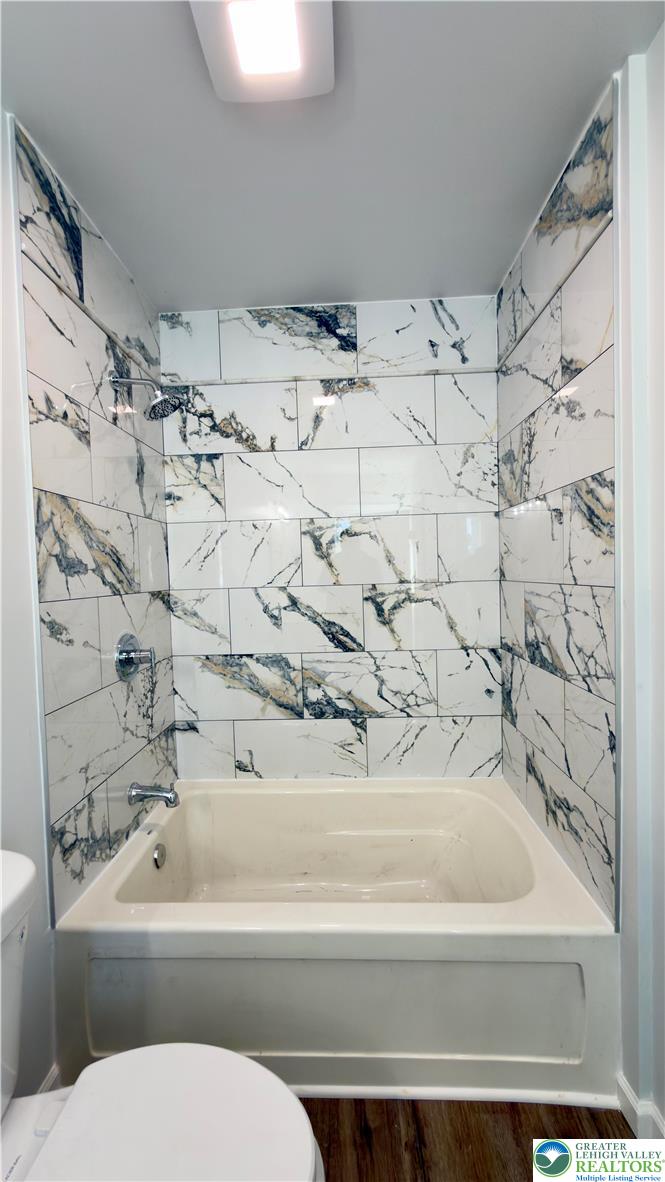 403 North Walnut Street, Unit B Bath, PA 18014 - Photo 17 of 31 a bathroom with a toilet and a bathtub