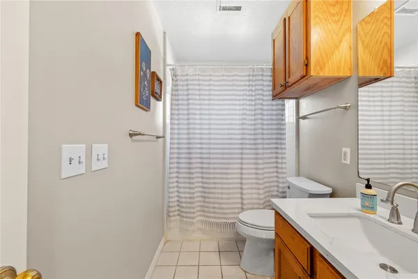 a bathroom with a sink a toilet and mirror