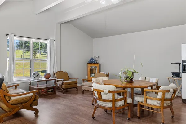 a dining room with furniture and a window