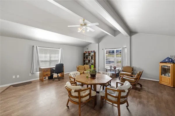 a dining room with furniture and wooden floor