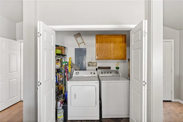a view of storage and utility room with washer and dryer