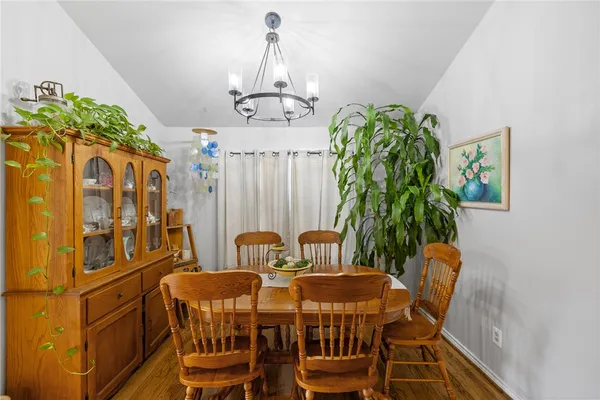 a view of a dining room with furniture and chandelier