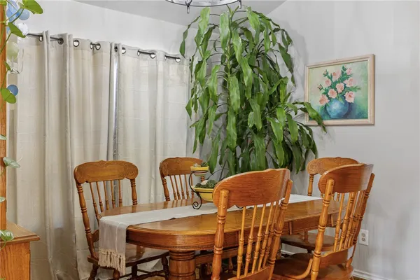 a view of a dining room with furniture and a potted plant