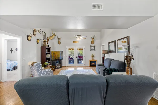 a living room with furniture a chandelier and a window
