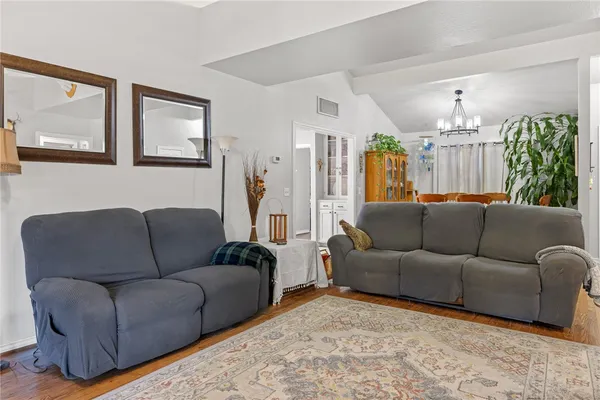 a living room with furniture and a chandelier