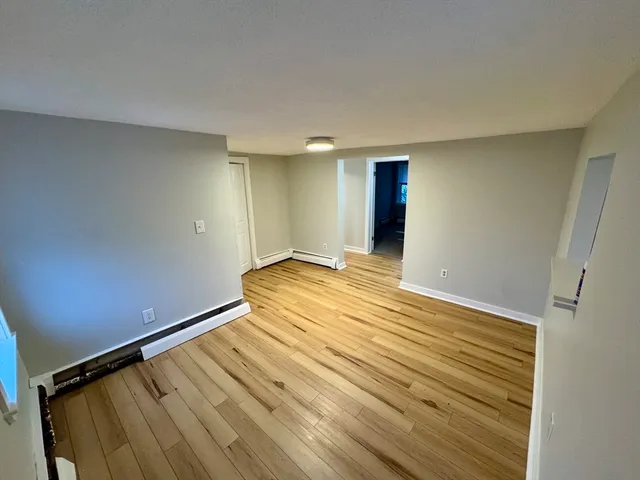 a view of a room with wooden floor