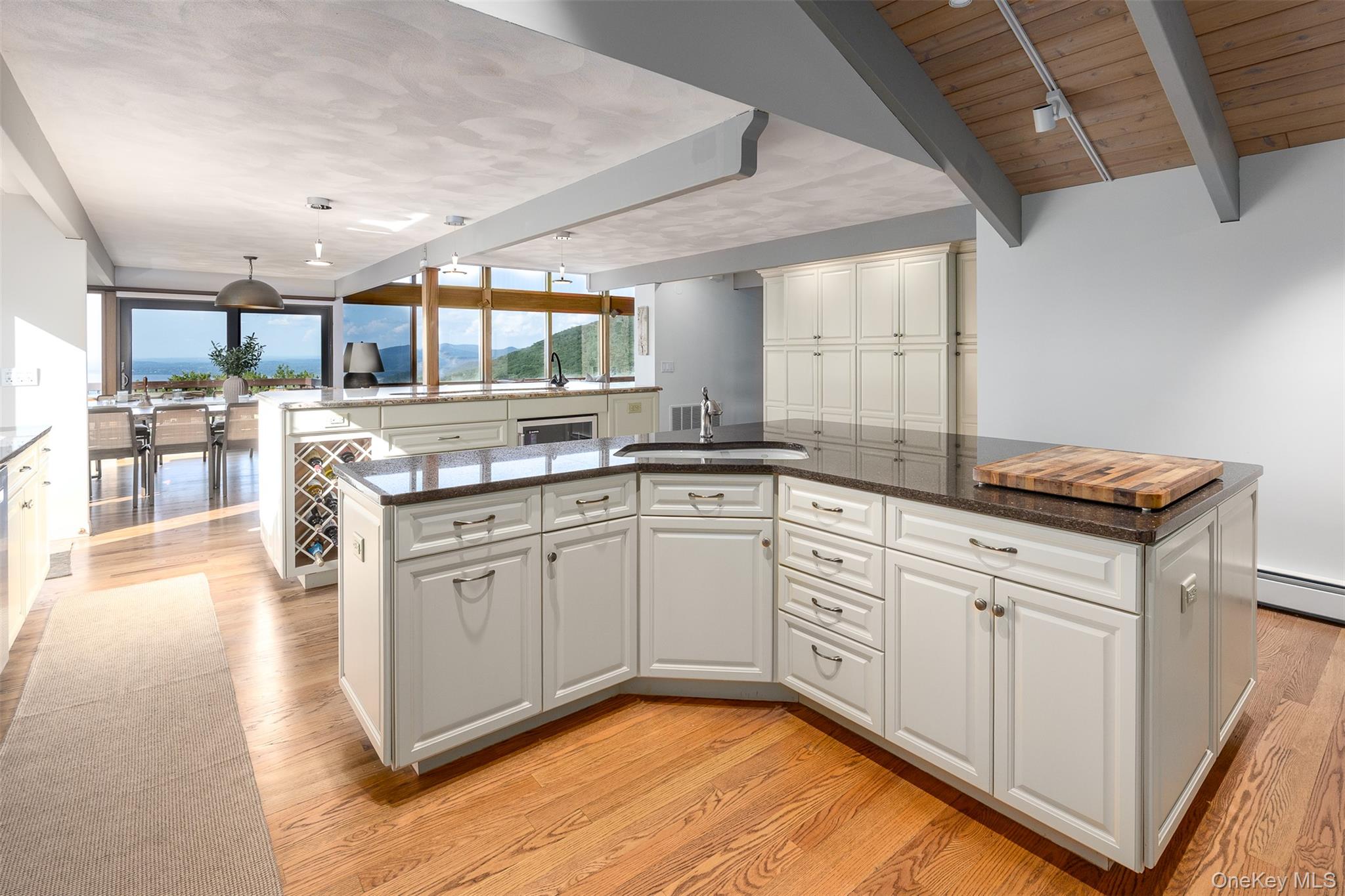 12 Mountain Brook Road Cornwall, NY 12518 - Photo 21 of 50 Kitchen featuring an island with sink, white cabinetry, light wood-type flooring, a wood ceiling with exposed beams, and dark stone counters
