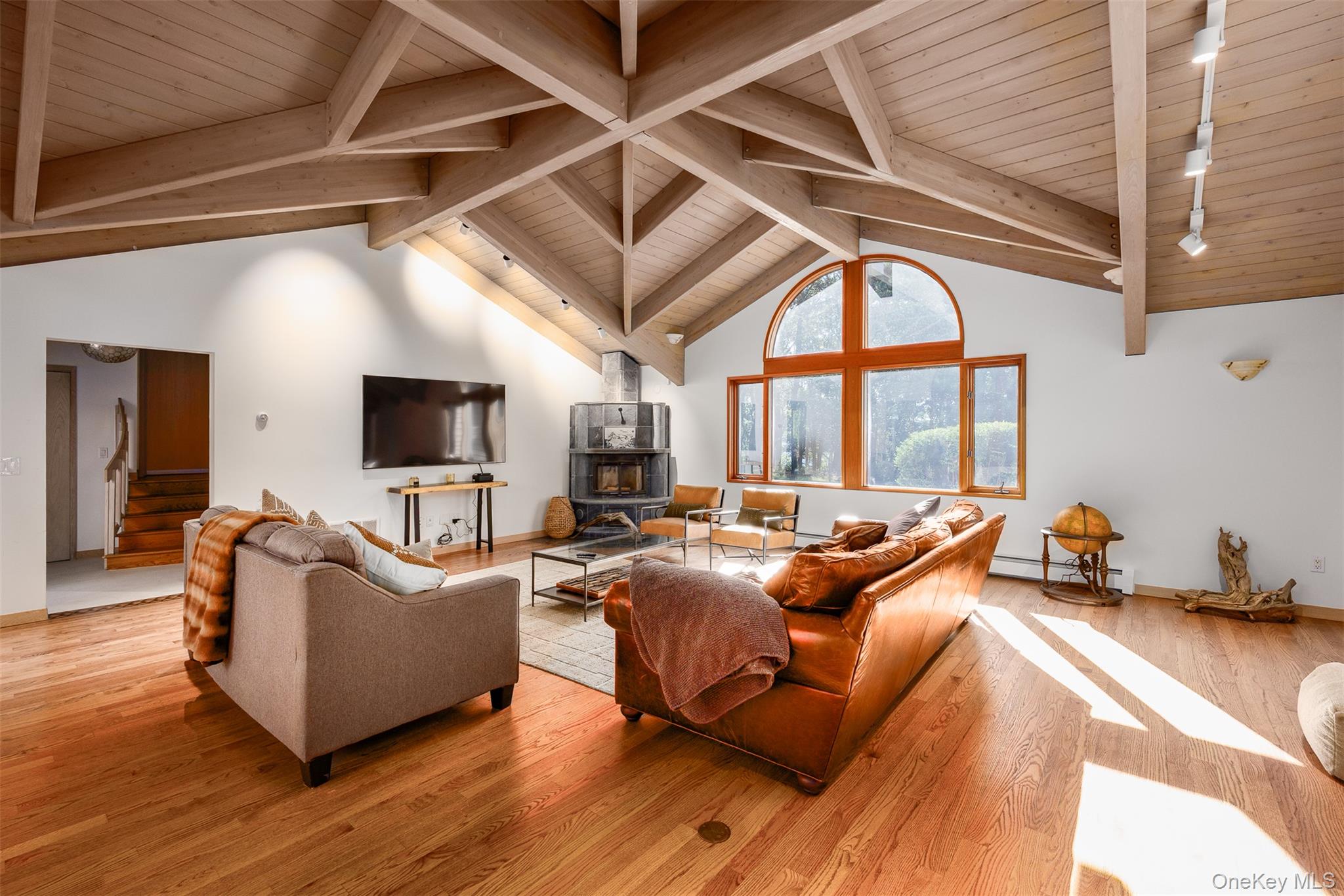12 Mountain Brook Road Cornwall, NY 12518 - Photo 27 of 50 Living room with a wooden ceiling with exposed beams, light wood-type flooring, stairway, high vaulted ceiling, and a wood stove
