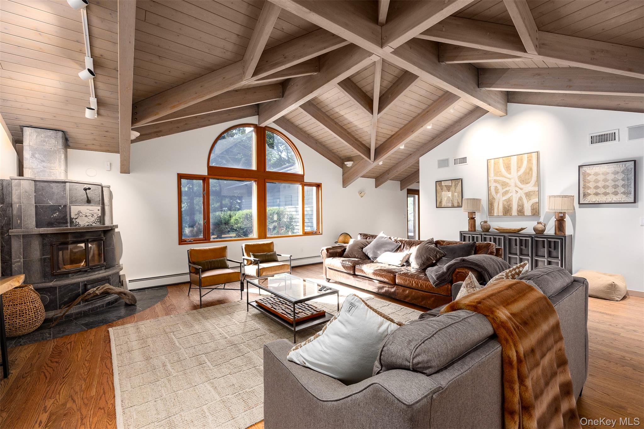 12 Mountain Brook Road Cornwall, NY 12518 - Photo 28 of 50 Living area with wood finished floors, a wood ceiling with exposed beams, high vaulted ceiling, a wood stove, and baseboard heating