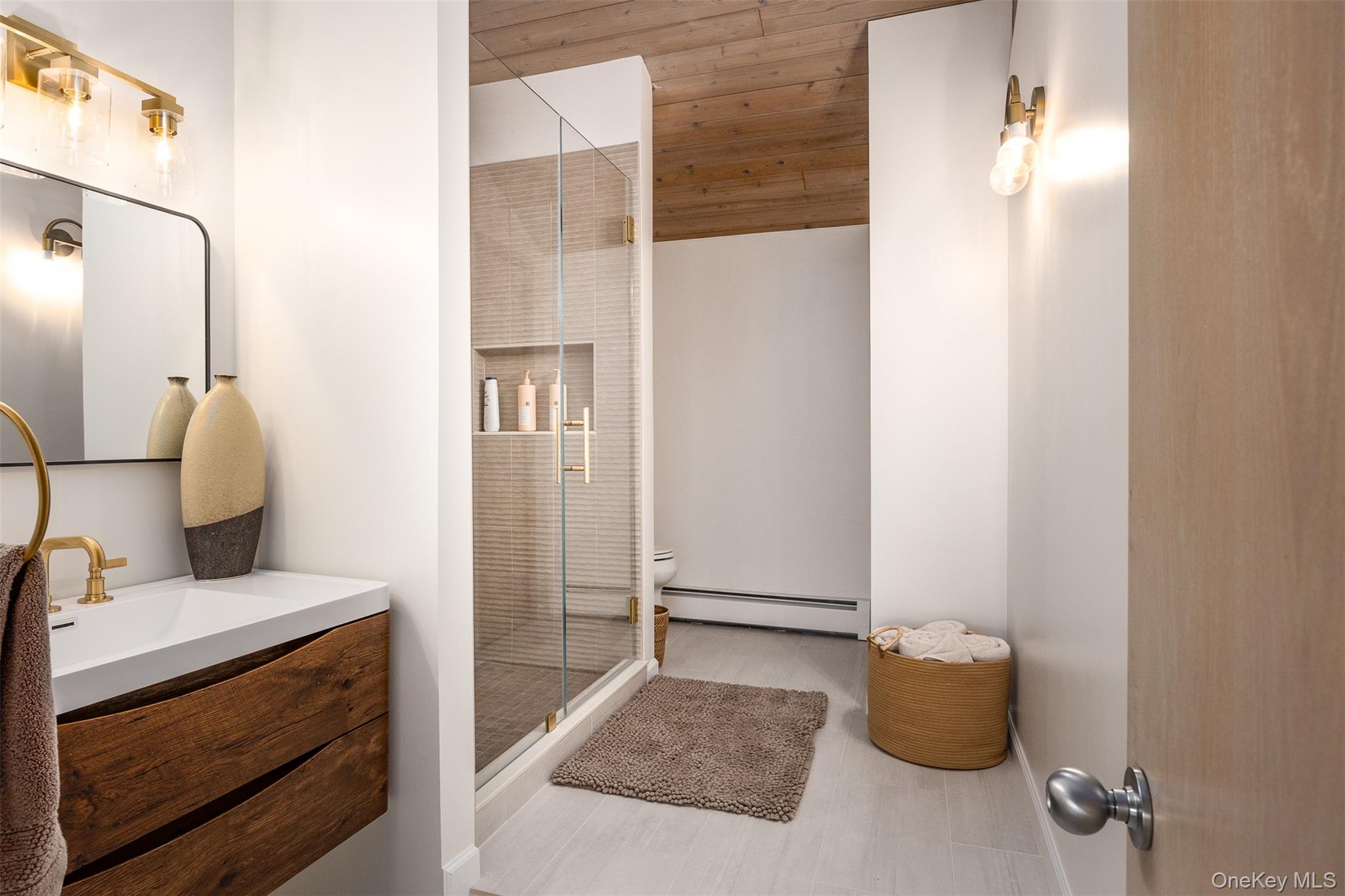 12 Mountain Brook Road Cornwall, NY 12518 - Photo 36 of 50 Bathroom featuring vanity, a stall shower, and a baseboard radiator