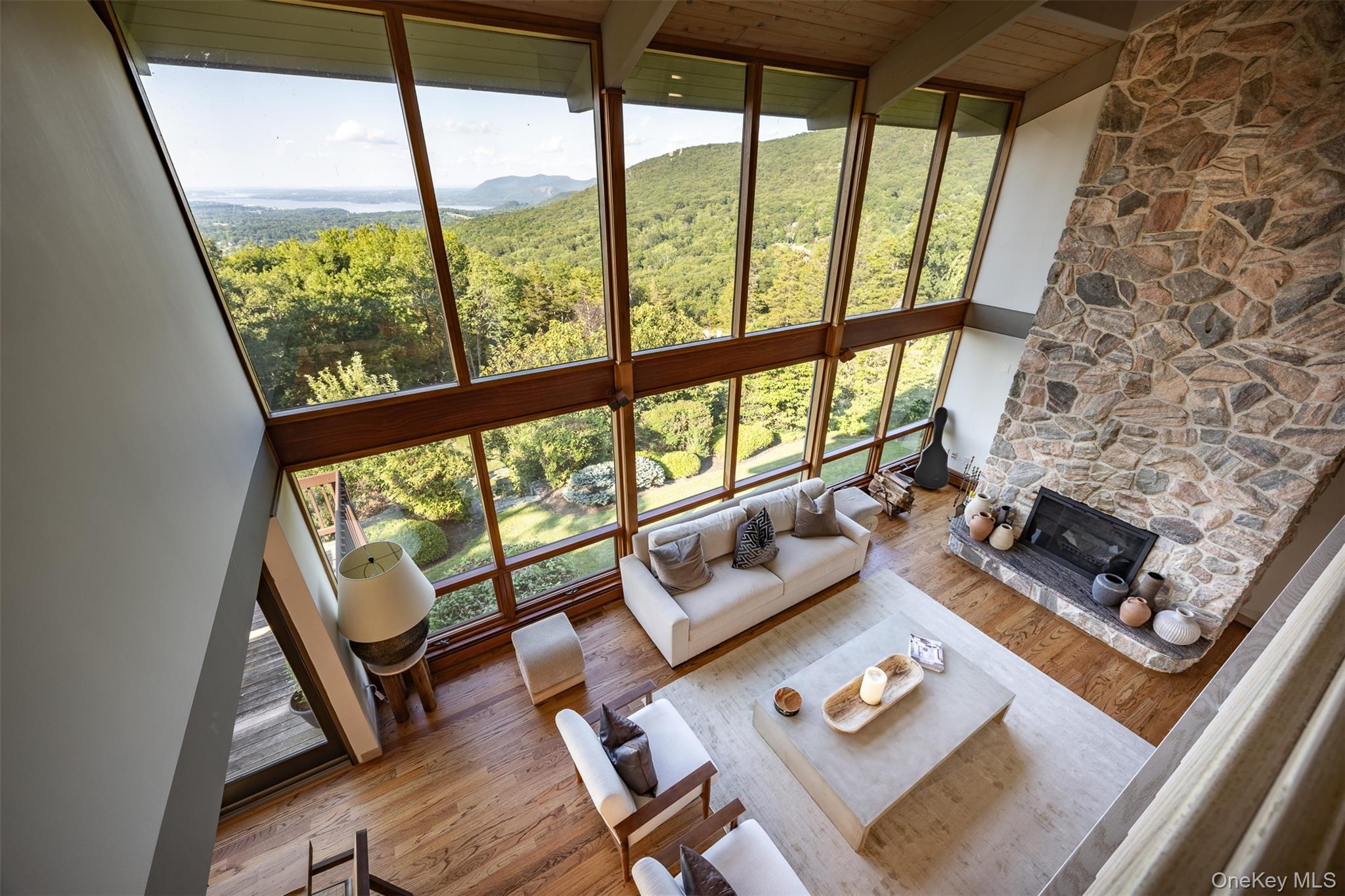 12 Mountain Brook Road Cornwall, NY 12518 - Photo 38 of 50 Living room with healthy amount of natural light, a wall of windows, wood finished floors, high vaulted ceiling, and a fireplace