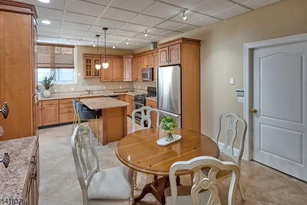 a dining room with furniture and window
