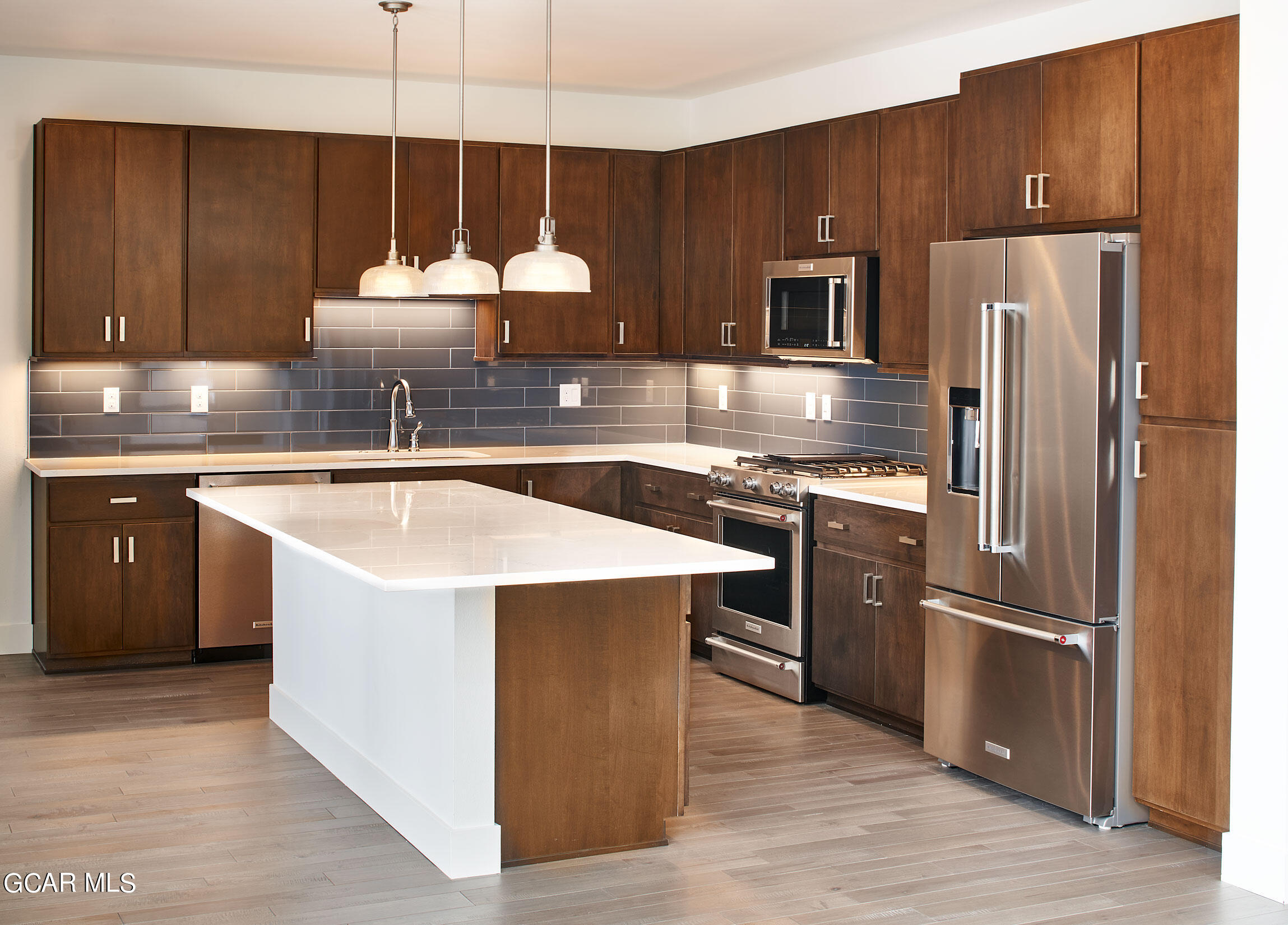 110 River Run Circle Fraser, CO 80442 - Photo 3 of 13 a kitchen with a sink refrigerator and microwave
