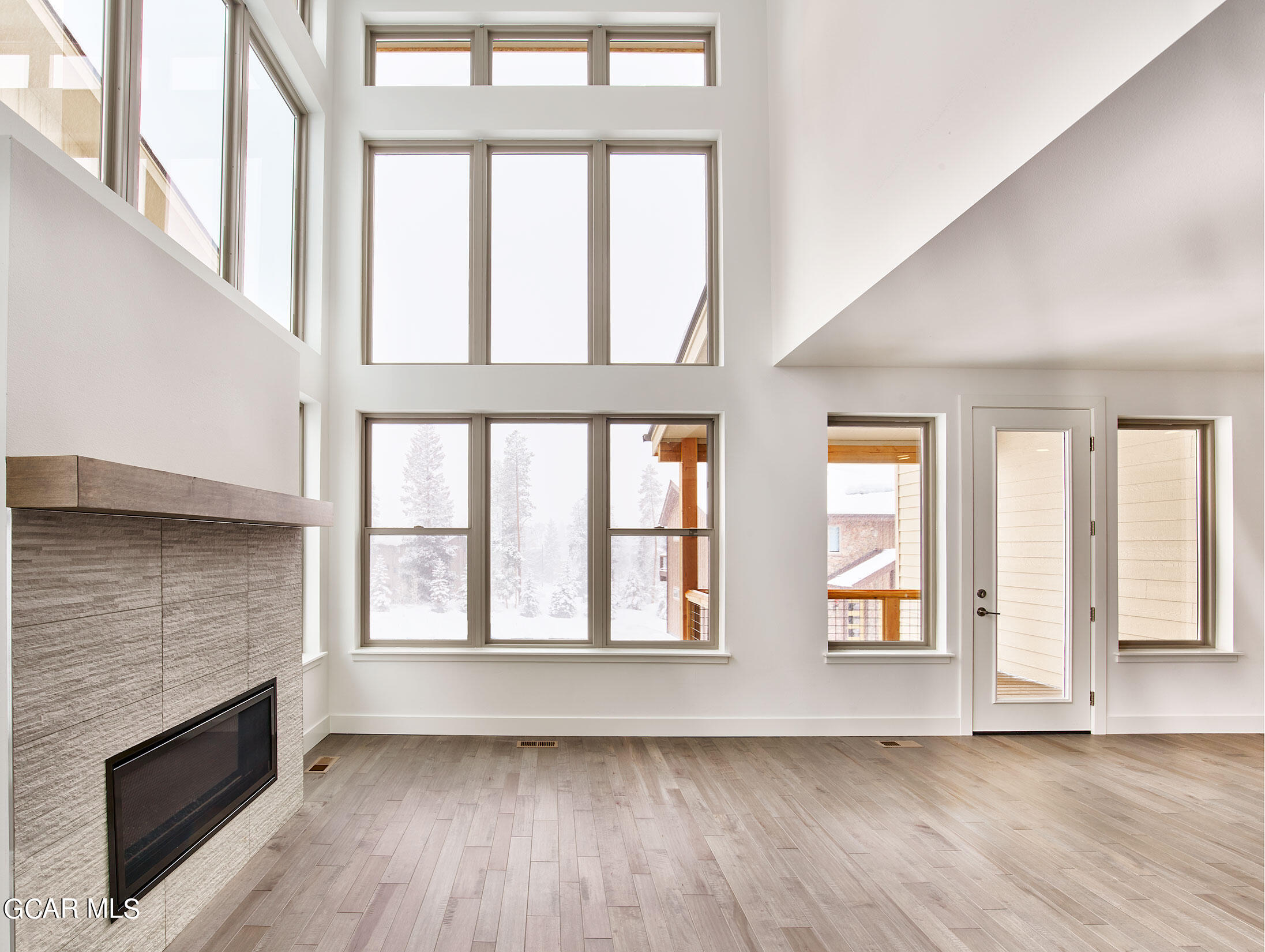 110 River Run Circle Fraser, CO 80442 - Photo 7 of 13 an empty room with wooden floor and windows