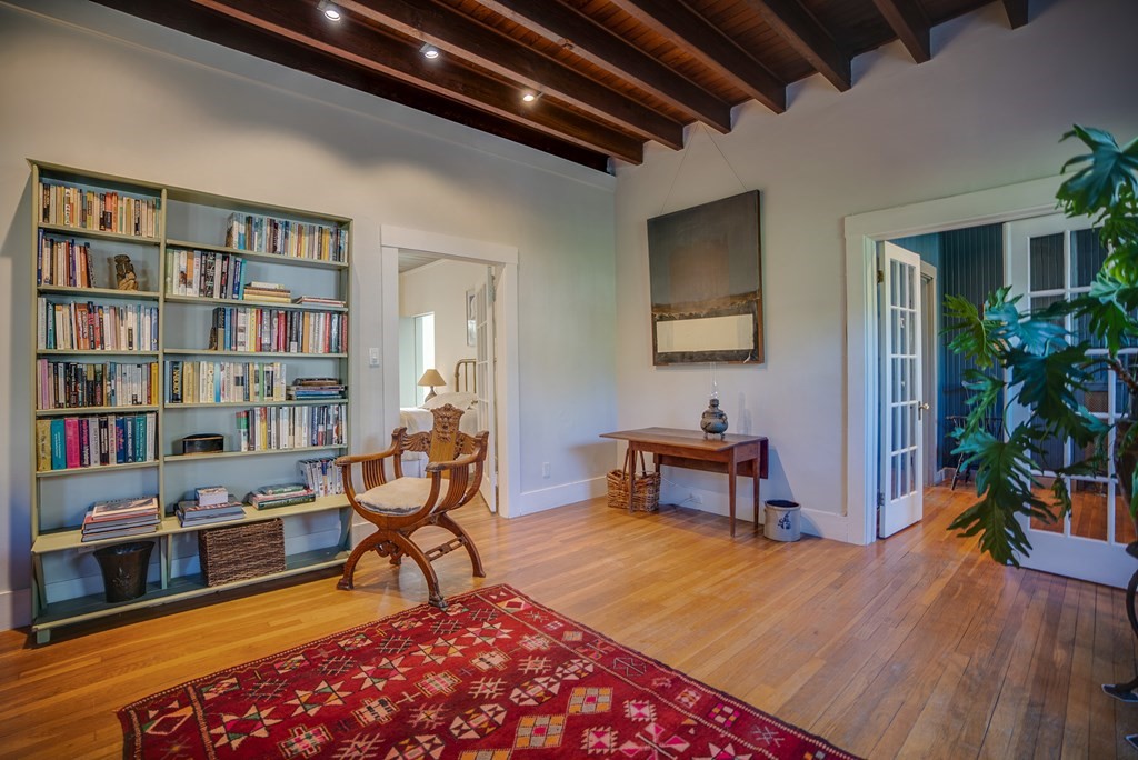 9 Addison Street Arlington, MA 02476 - Photo 12 of 41 a living room with furniture a rug and a bookshelf