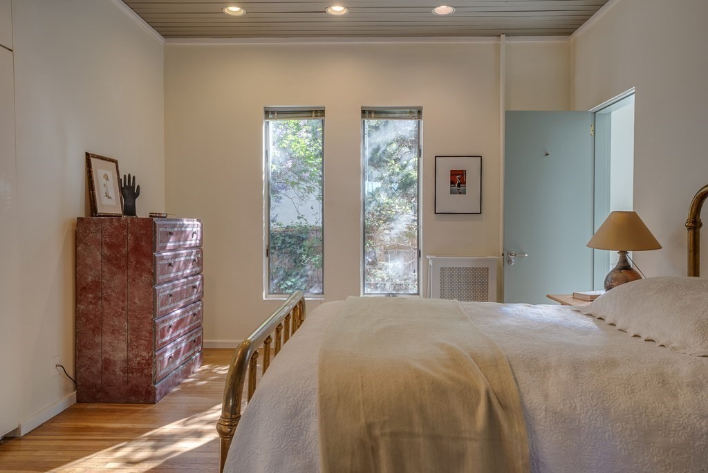 9 Addison Street Arlington, MA 02476 - Photo 18 of 41 a bedroom with a bed and a painting on the wall