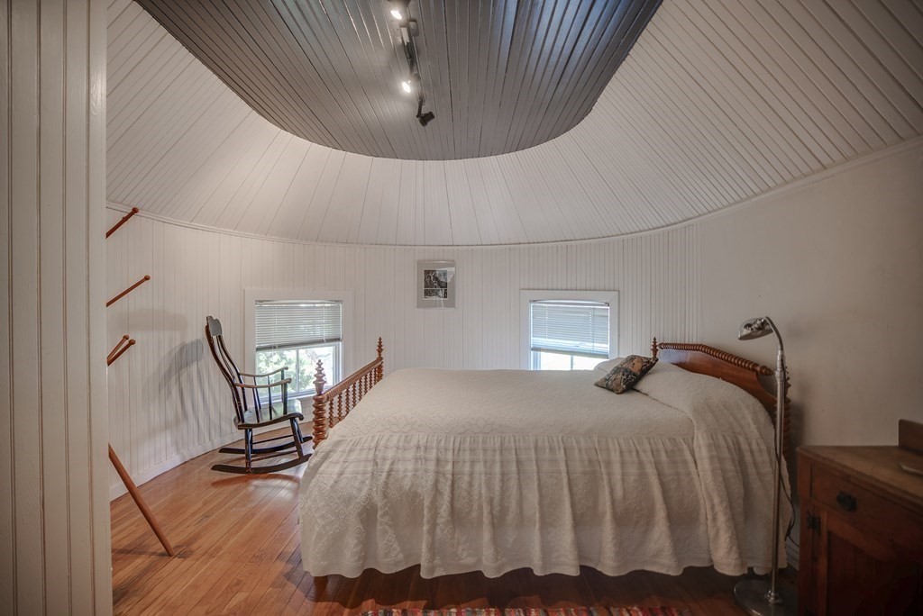 9 Addison Street Arlington, MA 02476 - Photo 22 of 41 a bedroom with a bed window and chandelier