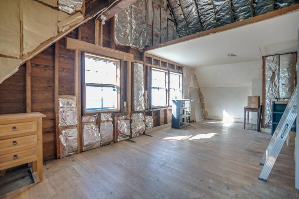 9 Addison Street Arlington, MA 02476 - Photo 24 of 41 a view of an empty room with wooden floor and windows