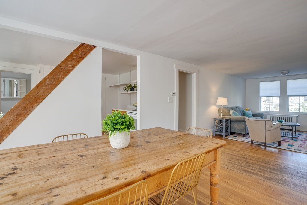 9 Addison Street Arlington, MA 02476 - Photo 28 of 41 a view of a dining room with furniture a potted plant and wooden floor