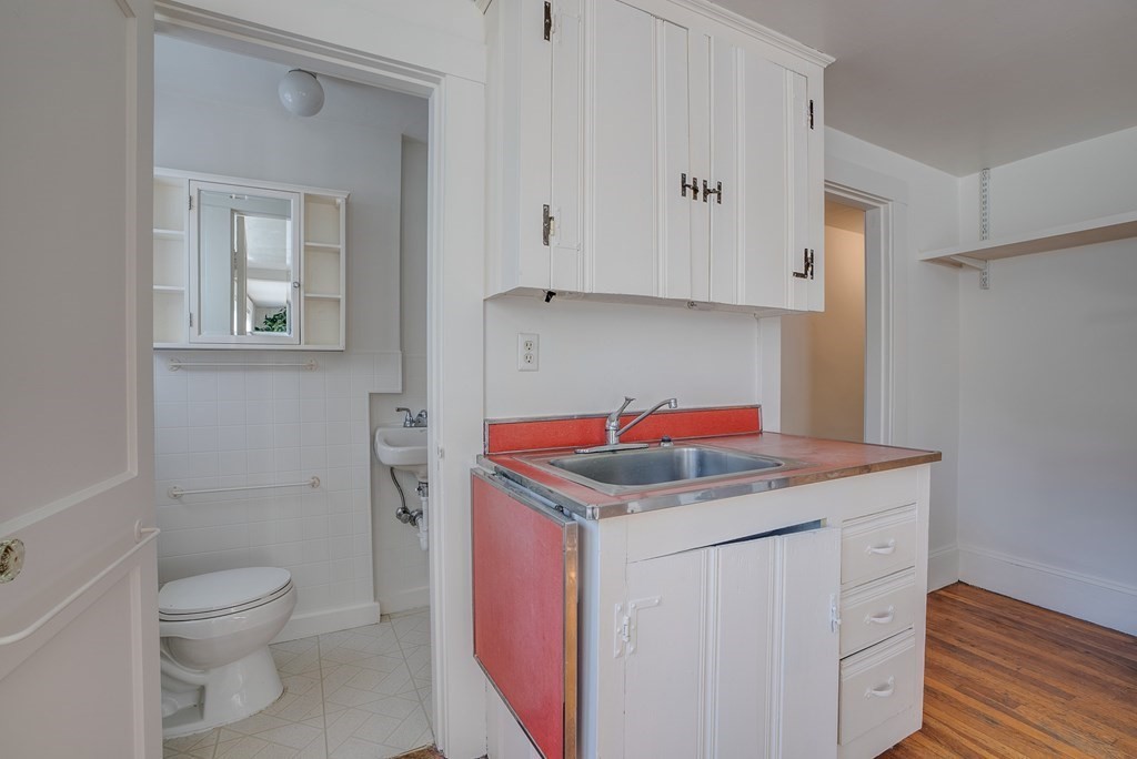 9 Addison Street Arlington, MA 02476 - Photo 32 of 41 a utility room with a sink a toilet and vanity