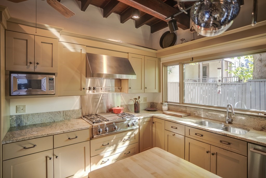 9 Addison Street Arlington, MA 02476 - Photo 6 of 41 a kitchen with granite countertop a sink stainless steel appliances and cabinets
