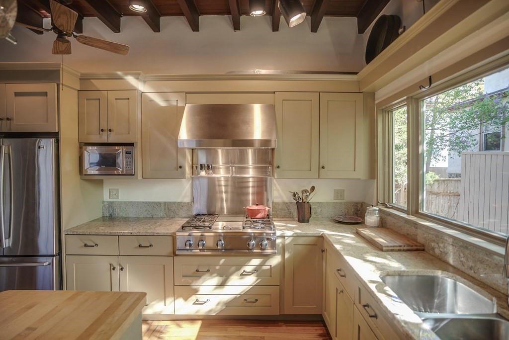 9 Addison Street Arlington, MA 02476 - Photo 7 of 41 a kitchen with stainless steel appliances granite countertop a sink and a stove