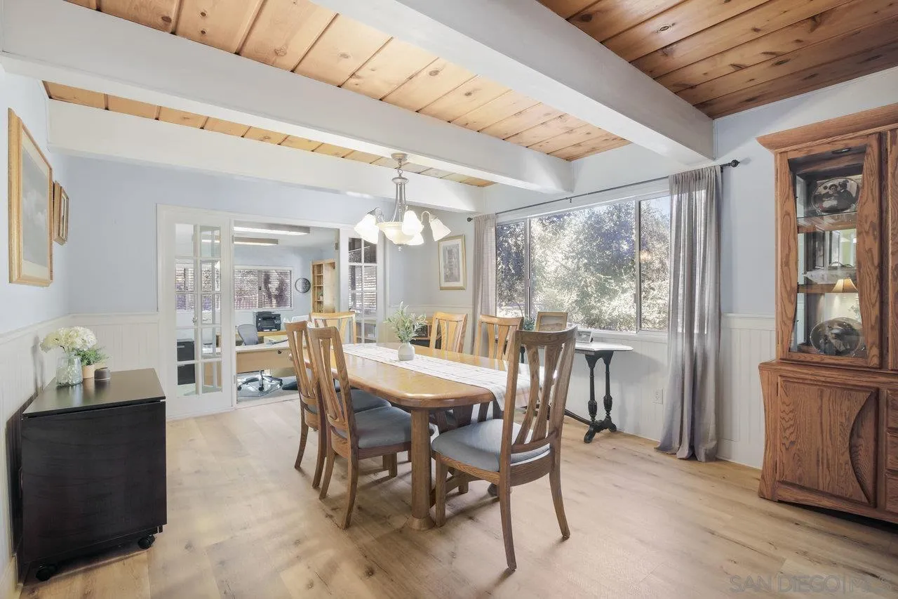 9018 Vernal Lane Descanso, CA 91916 - Photo 12 of 56 a view of a dining room with furniture large windows and wooden floor
