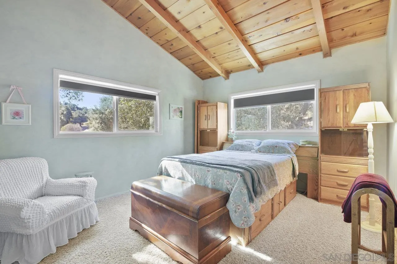 9018 Vernal Lane Descanso, CA 91916 - Photo 17 of 56 a spacious bedroom with a bed and a couch