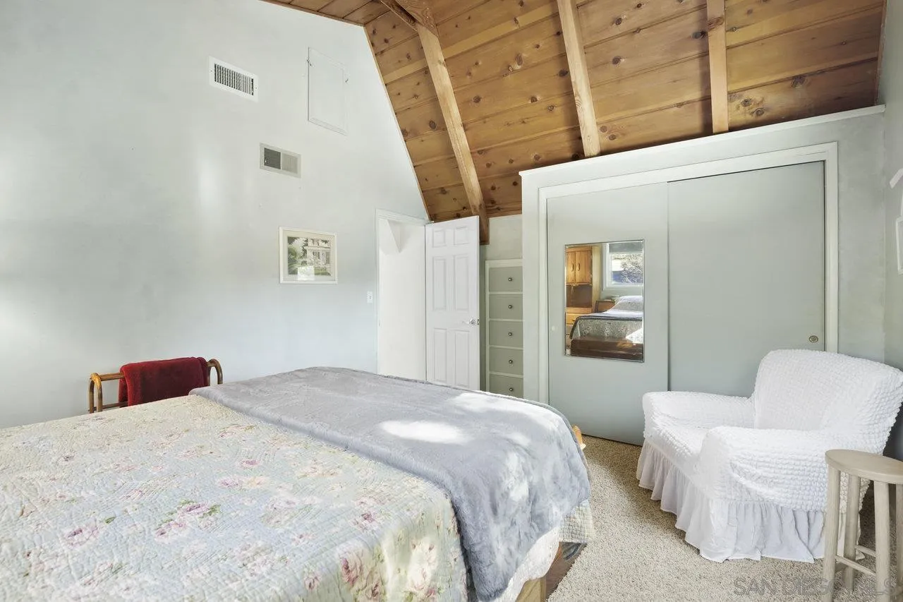 9018 Vernal Lane Descanso, CA 91916 - Photo 18 of 56 a bedroom with a bed and a mirror