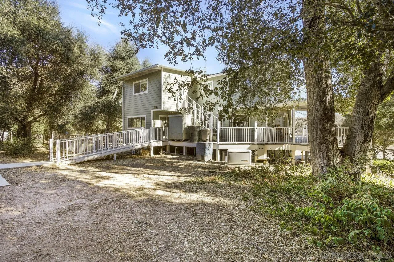 9018 Vernal Lane Descanso, CA 91916 - Photo 30 of 56 a view of a house with backyard and trees