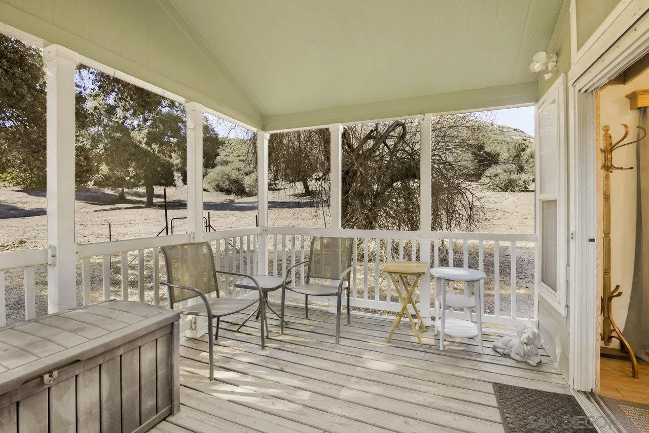 9018 Vernal Lane Descanso, CA 91916 - Photo 32 of 56 a dining room with wooden floor glass table and chairs