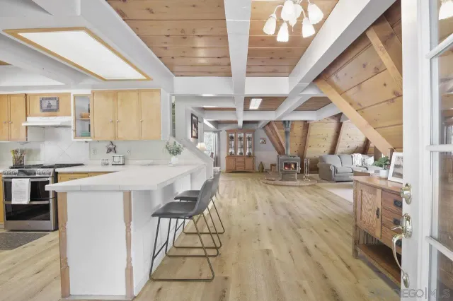 a open kitchen with sink and a refrigerator