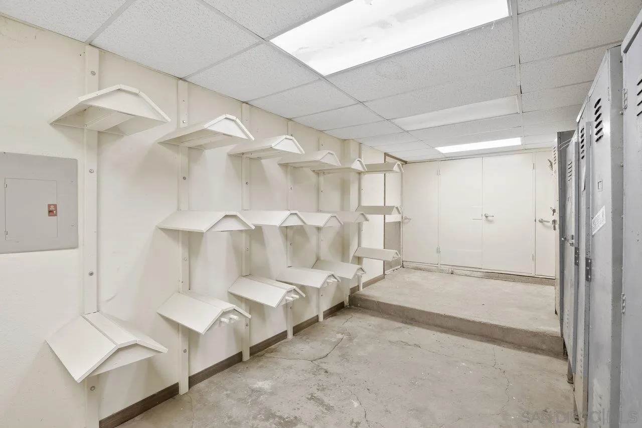 9018 Vernal Lane Descanso, CA 91916 - Photo 45 of 56 a spacious bedroom with a bed and a chandelier