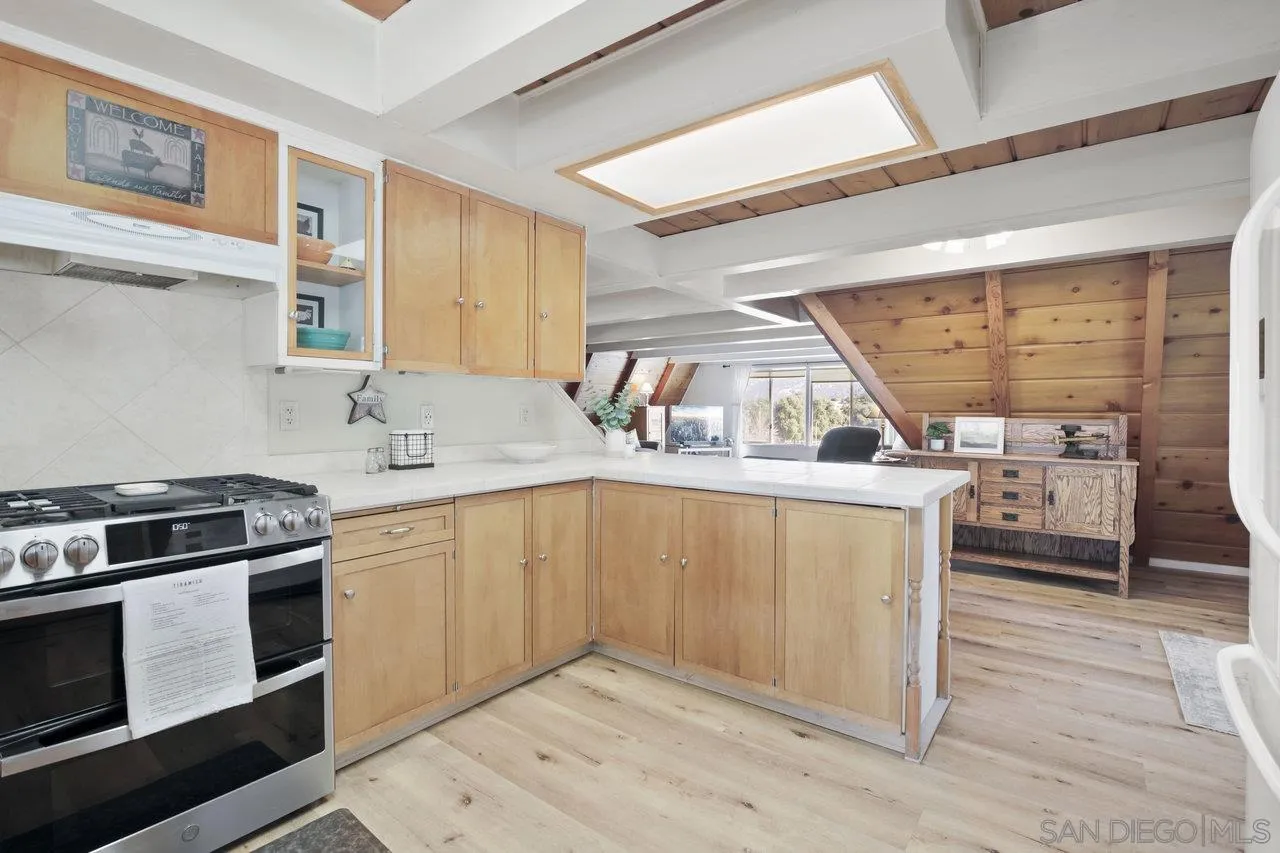 9018 Vernal Lane Descanso, CA 91916 - Photo 7 of 56 a kitchen with a stove a sink and a refrigerator