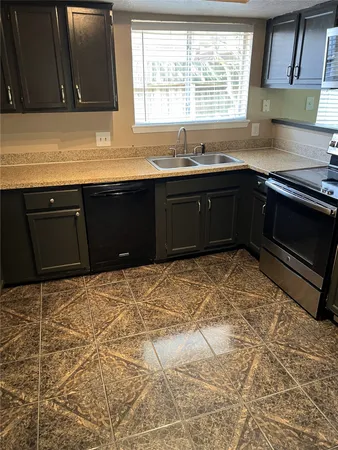 a kitchen with a sink and a stove