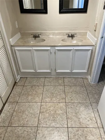 a bathroom with a sink and cabinets