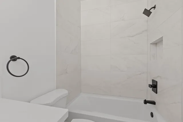a bathroom with a bathtub and a shower