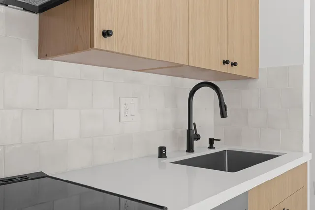 a kitchen with a sink and cabinets