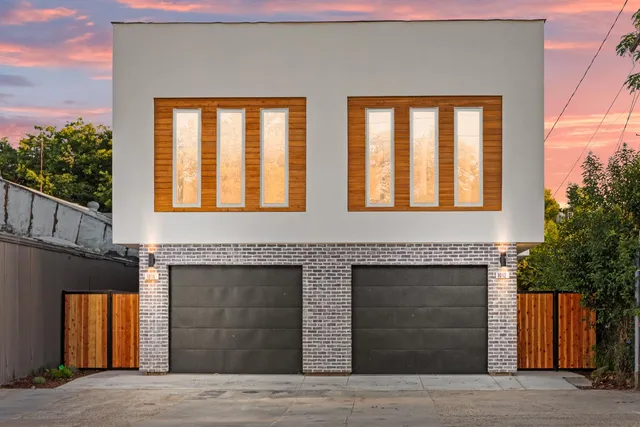 a front view of a brick house with large windows
