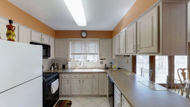 1870 Golfview Drive Bartlett, IL 60103 - Photo 6 of 15 a kitchen with a sink stove and cabinets