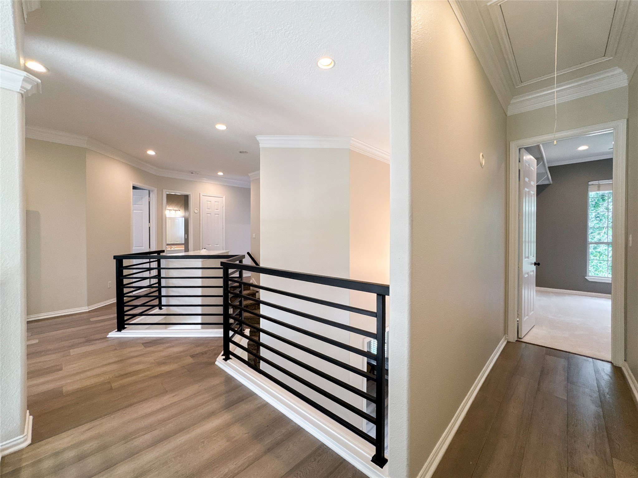 1810 Woerner Road Houston, TX 77090 - Photo 31 of 39 Experience the elegance of this second-floor landing, featuring modern railings and rich wood flooring, seamlessly connecting the upstairs rooms.